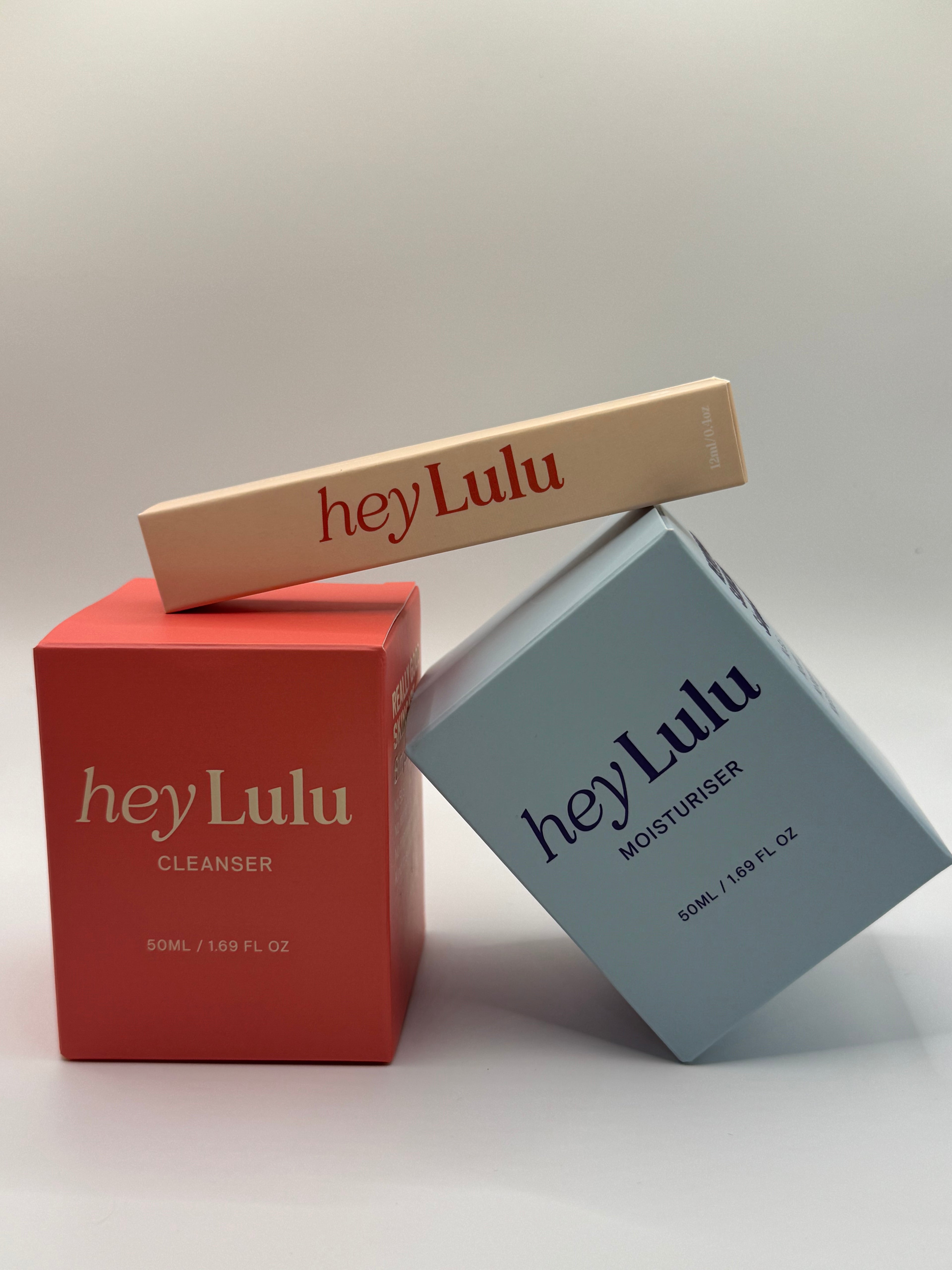 hey Lulu tween skincare essentials bundle with gentle cleanser, moisturiser and lip balm packaging styled together on a white background